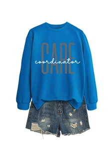 Detail of bright blue crewneck sweatshirt and distressed denim shorts with frayed hems