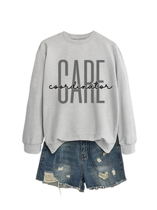 Detailed flat lay of a light grey CARE coordinator sweatshirt and distressed denim shorts