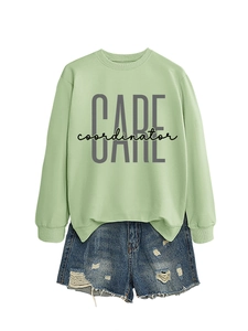 Detail of light green sweatshirt featuring grey CARE coordinator print and ribbed cuffs