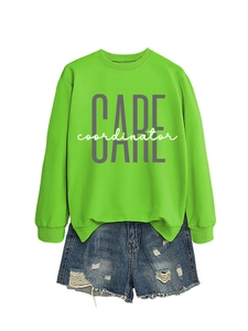 Detailed view of neon green CARE coordinator sweatshirt paired with distressed denim shorts