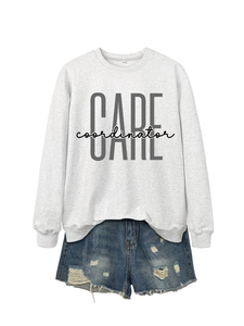 Flat lay detail of grey cotton sweatshirt with CARE coordinator print and denim shorts