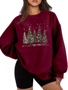 Detail of burgundy Winter Wonderland sweatshirt showing pine forest print and soft fabric