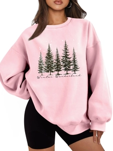 Close-up of pine forest graphic and Winter Wonderland text on pink oversized sweatshirt