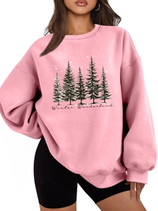 Detailed close-up of pink oversized sweatshirt featuring forest trees and star prints