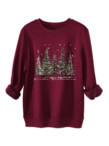 Detail of dark red plush sweatshirt featuring winter wonderland pine tree print and ribbed cuffs