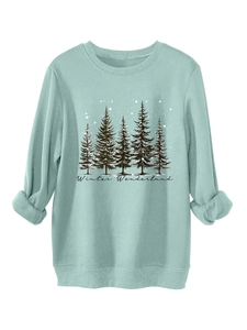 Detail of light green sweatshirt with Winter Wonderland pine tree print and ribbed cuffs