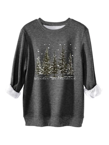 Close-up of charcoal grey sweatshirt with winter forest print and soft fleece lining