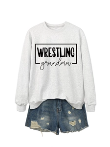 Detail of light grey drop shoulder sweatshirt with Wrestling Grandma text and denim shorts
