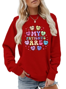 Detail of red crewneck sweatshirt with heart graphics and medical care slogans