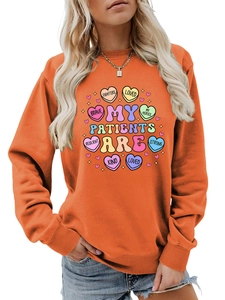 Detail of orange crewneck sweatshirt with heart pattern and My Patients Are text