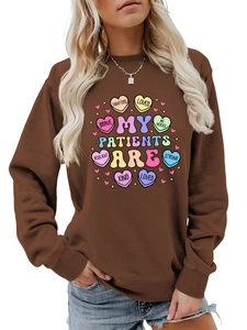 Detail of soft rib-knit cuffs and neckline on brown crewneck sweatshirt with heart print