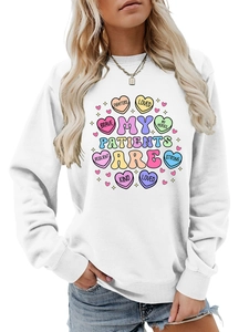 Detail of white cotton sweatshirt featuring colorful heart graphic and brave letters