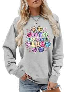 Detail of grey sweatshirt showing colorful My Patients Are heart print and text