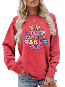 Detail of red crewneck sweatshirt with colorful nursing themed heart graphic print