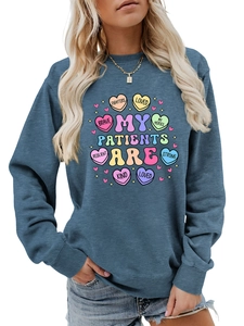Close-up of heart print with motivational words on navy long sleeve sweatshirt