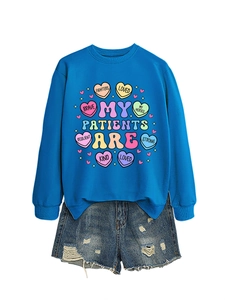 Close-up of royal blue crewneck sweatshirt with heart graphics and denim shorts