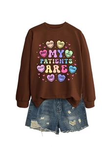 Brown crewneck sweatshirt with 'MY PATIENTS ARE' print paired with ripped denim shorts