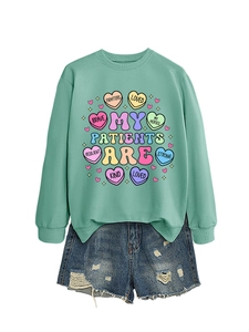 Detail of mint green sweatshirt with colorful heart candy prints and denim shorts set
