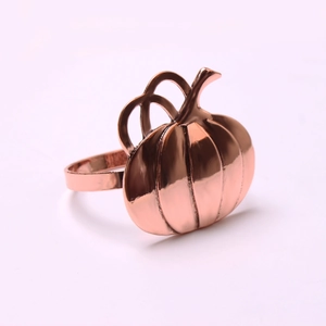 Detailed close-up of rose gold pumpkin napkin ring with polished metallic finish
