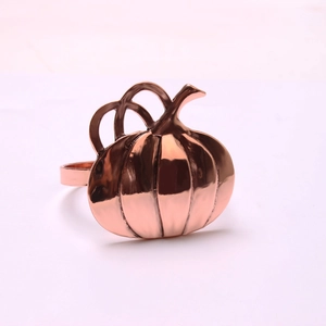Macro shot of rose gold pumpkin napkin ring with a polished metallic finish
