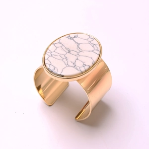 Polished golden open cuff napkin ring with a large white marble stone for hotel table decor