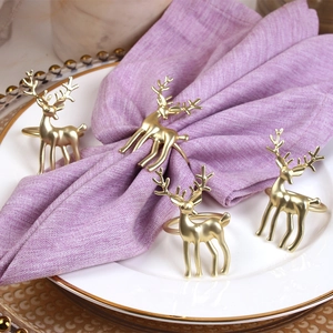 Set of four matte gold reindeer napkin rings for elegant holiday dining table decor