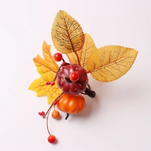 Detailed view of autumn napkin ring featuring foam pumpkins and yellow maple leaves