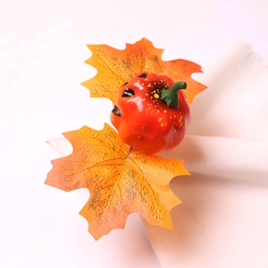 Halloween pumpkin napkin ring with orange jack-o-lantern and autumn maple leaf decoration