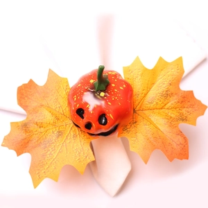 Halloween pumpkin napkin ring with golden maple leaves for festive holiday table decor