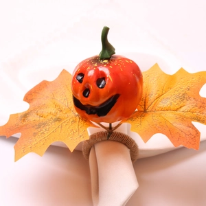 Detail of Halloween napkin ring with jack-o-lantern pumpkin and yellow maple leaves