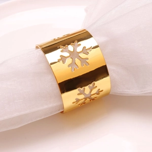 Elegant gold metal snowflake napkin rings for Christmas table settings and winter weddings