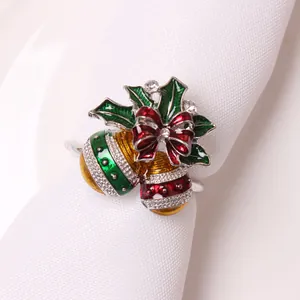 Close-up of Christmas napkin ring with enamel holly leaves and sparkling rhinestones