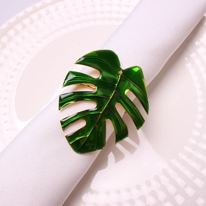 Monstera leaf napkin ring in gold metal and green enamel for elegant table settings