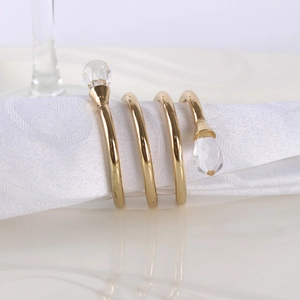 Golden spiral metal napkin ring featuring double crystal beads for elegant table settings