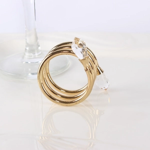 Elegant gold spiral napkin ring featuring dual crystal beads and a polished finish