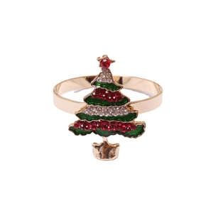 Golden Christmas tree napkin ring with green enamel and sparkling rhinestones on white background