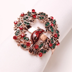 Detail of Christmas wreath napkin ring with red cardinal bird and sparkling gemstones