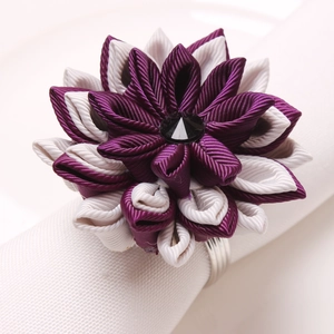 Handmade purple fabric lotus napkin ring with silver metal band and gemstone center