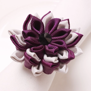 Handmade purple and cream layered ribbon lotus napkin ring with a faceted black gemstone center