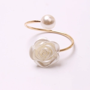 Elegant gold open ring featuring a white pearl and resin rose flower on a white background