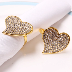 Sparkling gold heart napkin ring with clear rhinestones on white napkin decor