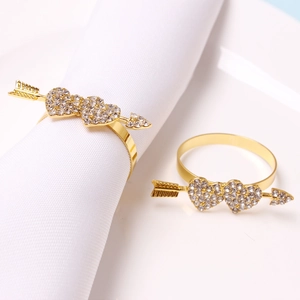 Golden double heart napkin rings with rhinestones on white napkin for table decor