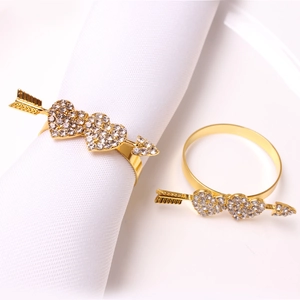 Detail of gold double heart napkin rings with crystals for Valentine dinner table