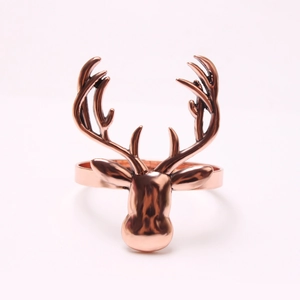 Macro detail of polished rose gold elk head napkin ring showing metallic luster