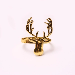 Detailed close-up of a golden elk head napkin ring featuring intricate metal antlers