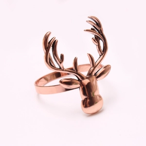 Detailed close-up of a rose gold reindeer head napkin ring with sleek metallic finish