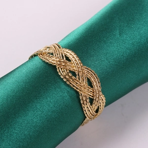 Braided gold metal napkin ring with intricate woven design for elegant table decor
