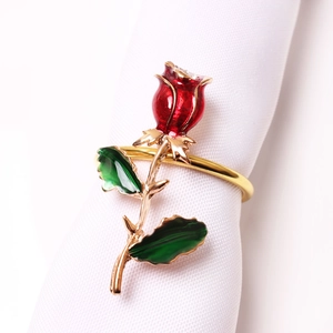 Elegant rose napkin ring with red enamel flower and golden metal stem for table decor