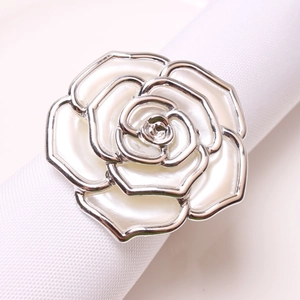 Macro view of silver rose napkin ring with cream white enamel flower petals details