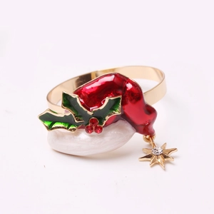 Close-up of a festive Christmas hat napkin ring with holly leaves and gold star charm